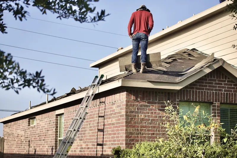 Professional roofer working on a residential roof in Progress